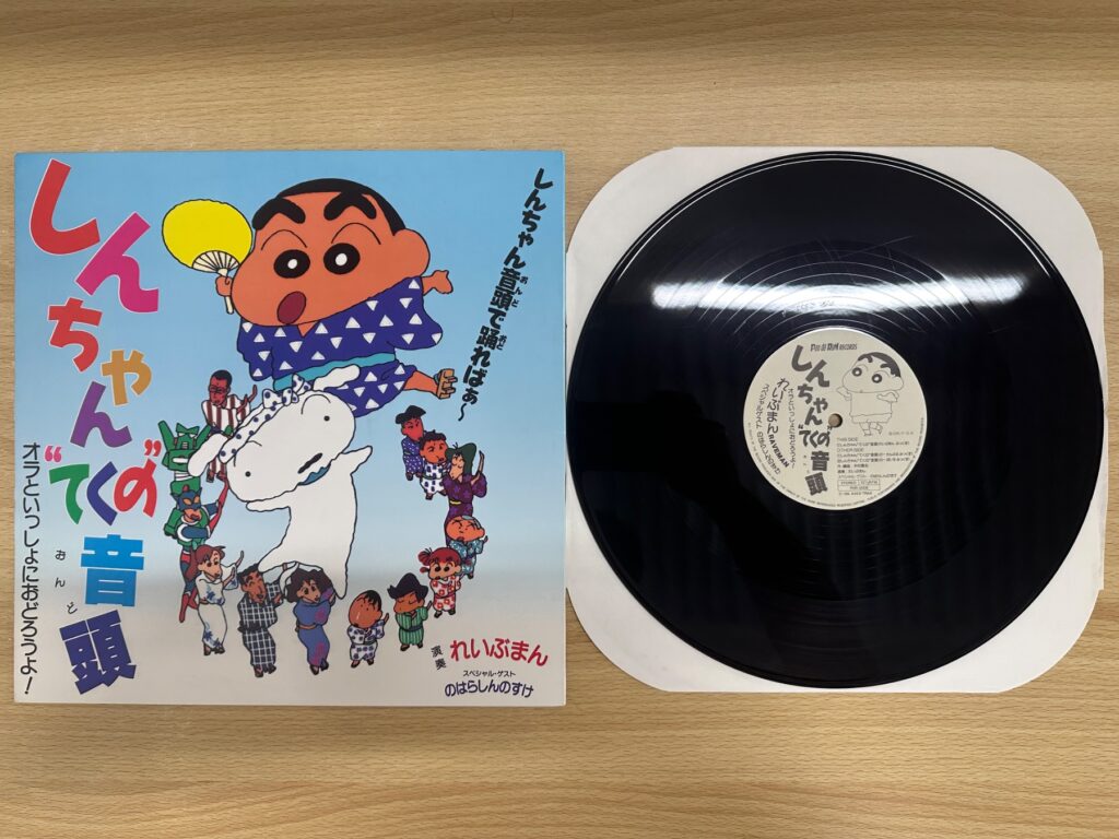 クレヨンしんちゃんが描かれた「しんちゃん音頭」のレコードジャケットと黒いアナログ盤